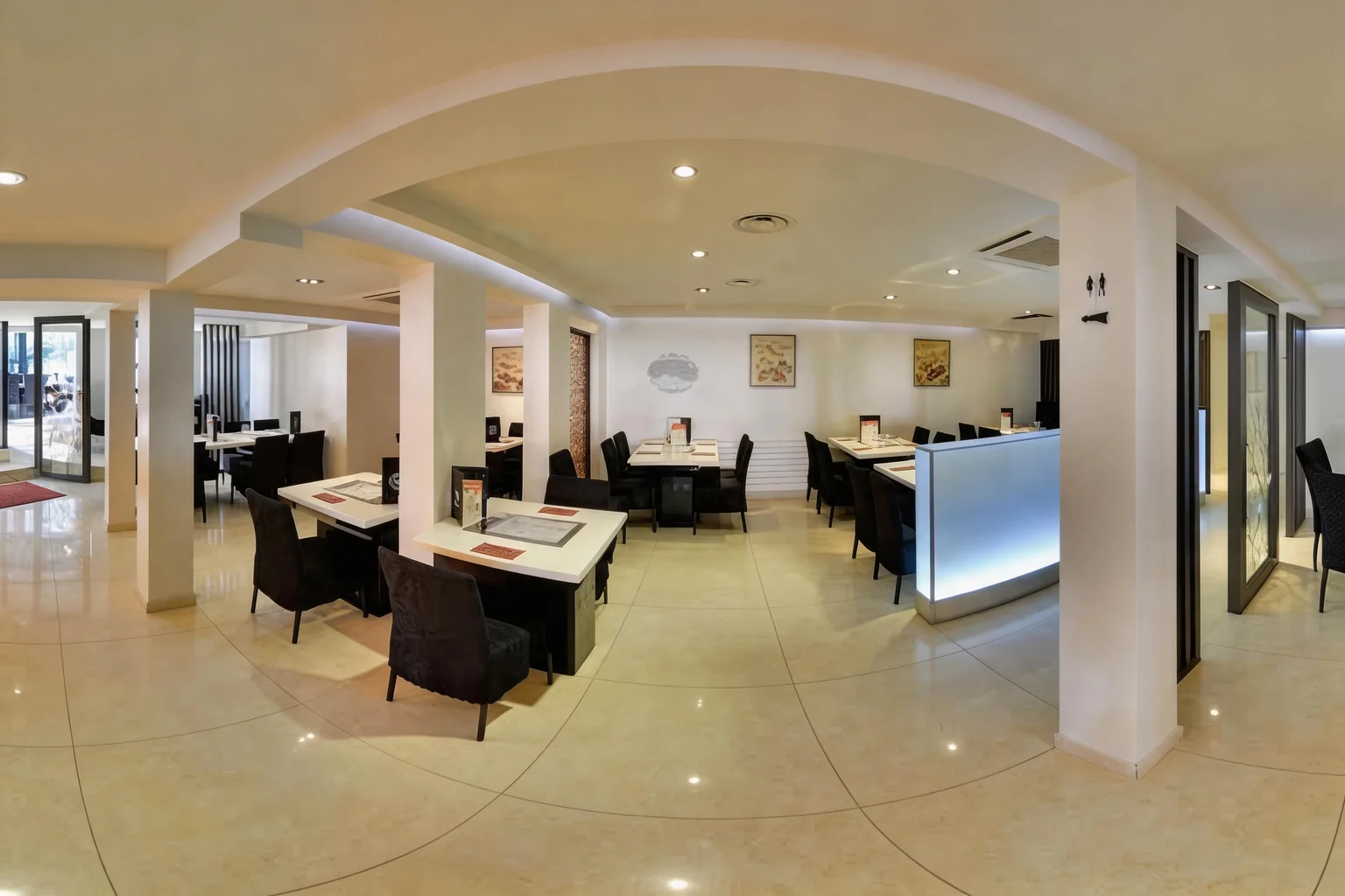 Dining room with white columns and laid tables